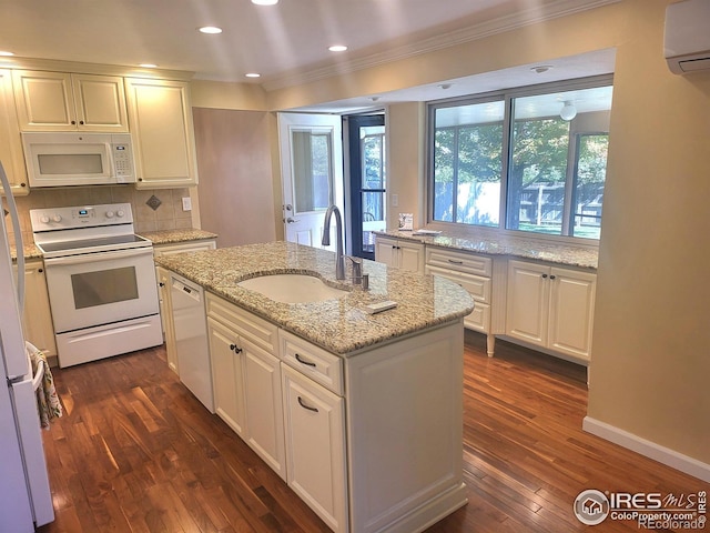 kitchen featuring light stone counters, dark hardwood / wood-style flooring, an island with sink, sink, and white appliances