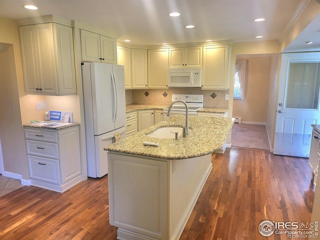 kitchen with white appliances, an island with sink, and dark hardwood / wood-style floors