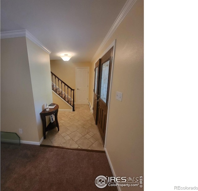 foyer entrance featuring crown molding and light carpet