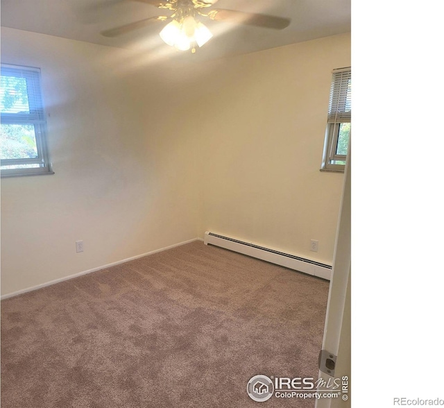 carpeted empty room with baseboard heating, plenty of natural light, and ceiling fan