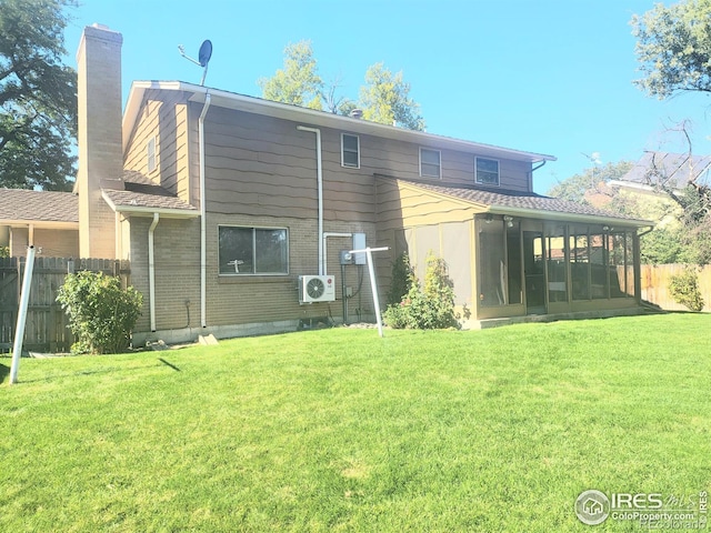 rear view of property featuring ac unit, a yard, and a sunroom