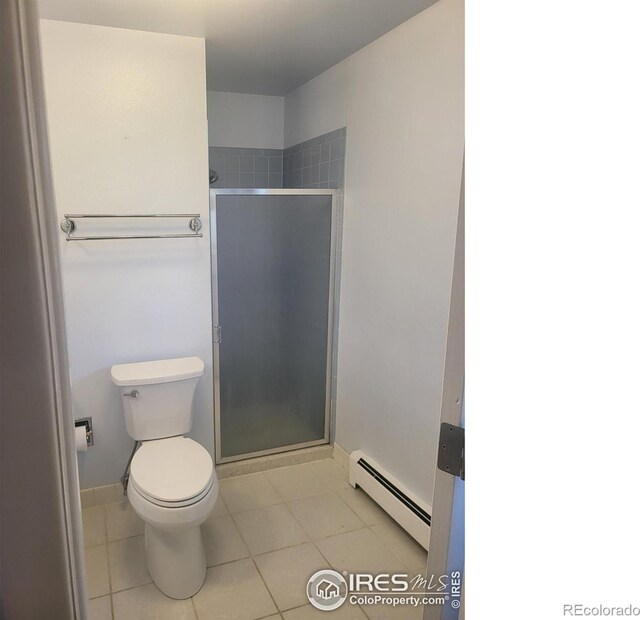 bathroom featuring a baseboard heating unit, an enclosed shower, toilet, and tile patterned flooring