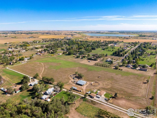 drone / aerial view featuring a water view and a rural view