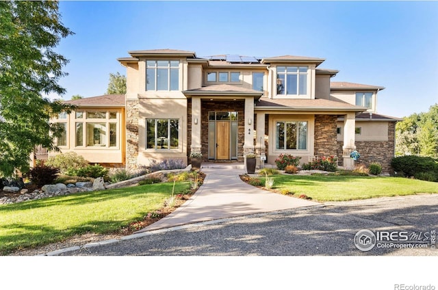 prairie-style home featuring a front lawn