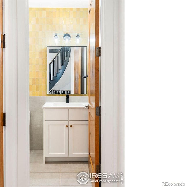 bathroom featuring tile walls and vanity