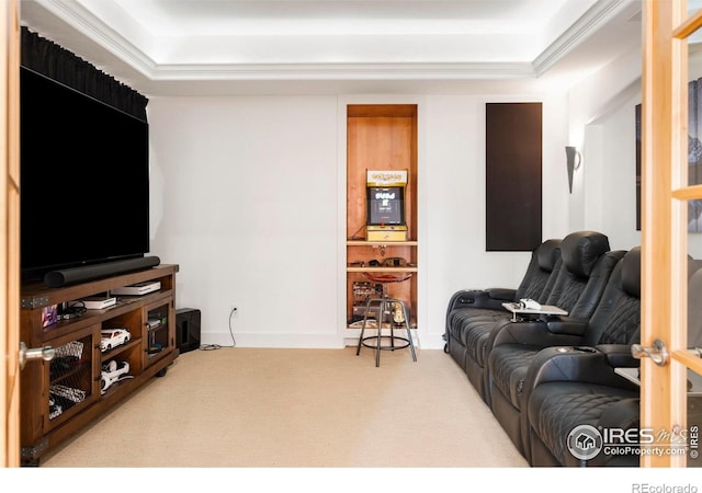 carpeted living room featuring ornamental molding and a tray ceiling