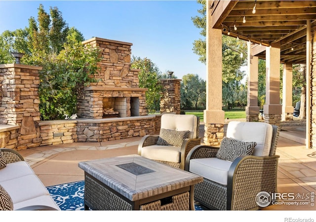 view of patio / terrace featuring an outdoor living space with a fireplace