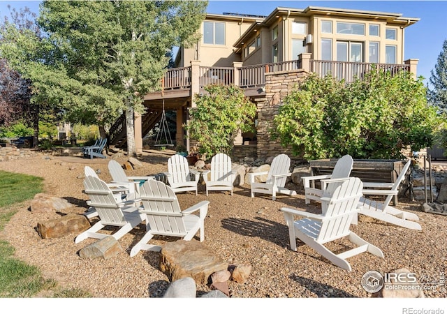 view of patio / terrace featuring a wooden deck and an outdoor fire pit