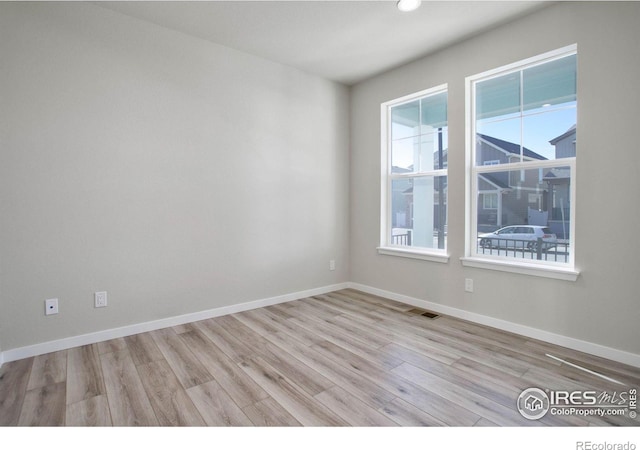 unfurnished room featuring light wood-type flooring