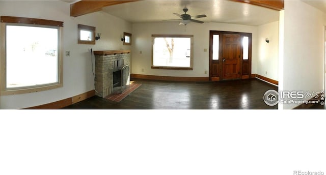 foyer with dark hardwood / wood-style floors, ceiling fan, a fireplace, and lofted ceiling with beams