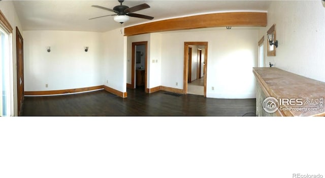 spare room with ceiling fan and dark wood-type flooring