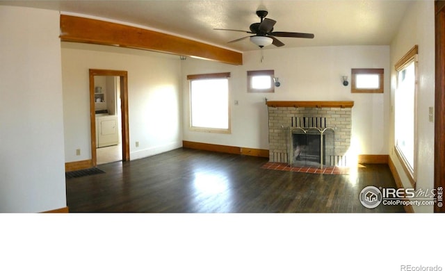 unfurnished living room with ceiling fan, a fireplace, dark wood-type flooring, and washer / dryer