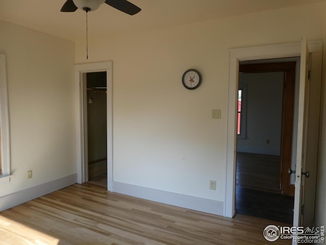 unfurnished bedroom featuring light wood-type flooring, a closet, and ceiling fan