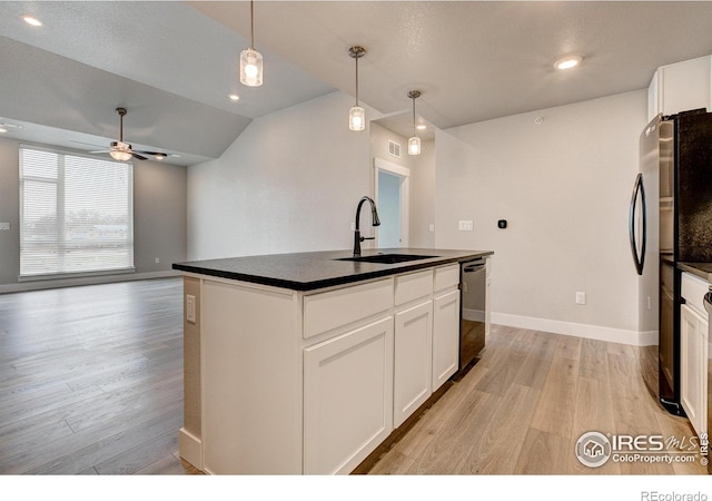 265 High Point Dr Unit 203, Longmont, CO 80504 - kitchen featuring a sink, dark countertops, freestanding refrigerator, dishwasher, and light wood-style flooring
