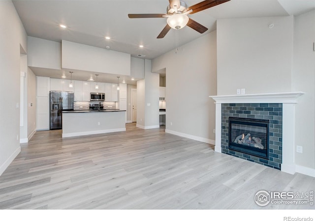 265 High Point Dr Unit 203, Longmont, CO 80504 - unfurnished living room featuring high vaulted ceiling, ceiling fan, light wood finished floors, recessed lighting, and baseboards