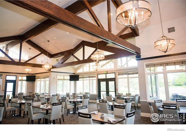 265 High Point Dr Unit 203, Longmont, CO 80504 - carpeted dining area with a chandelier, high vaulted ceiling, french doors, healthy amount of natural light, and beamed ceiling