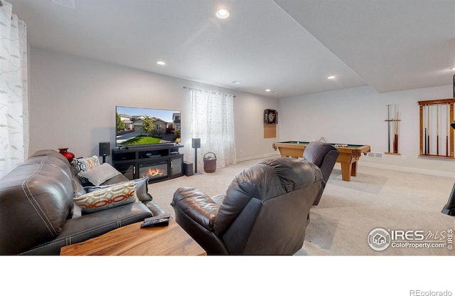 carpeted living room featuring visible vents, baseboards, a glass covered fireplace, pool table, and recessed lighting