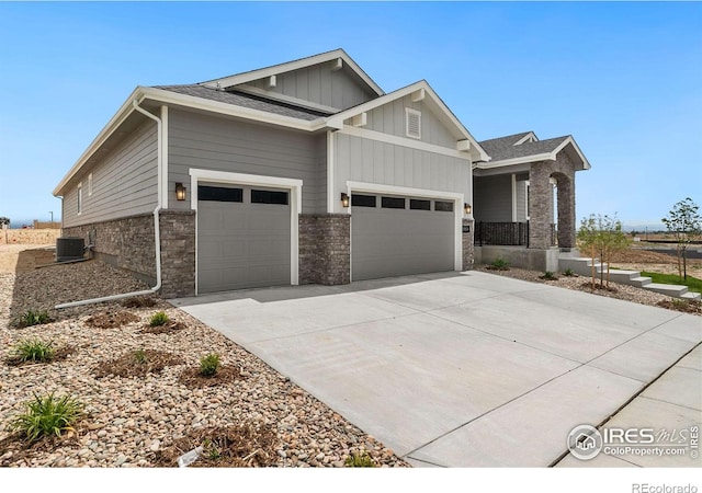 view of front of home featuring a garage and cooling unit