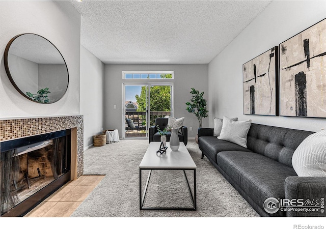 living room featuring light tile patterned floors, a textured ceiling, and a fireplace