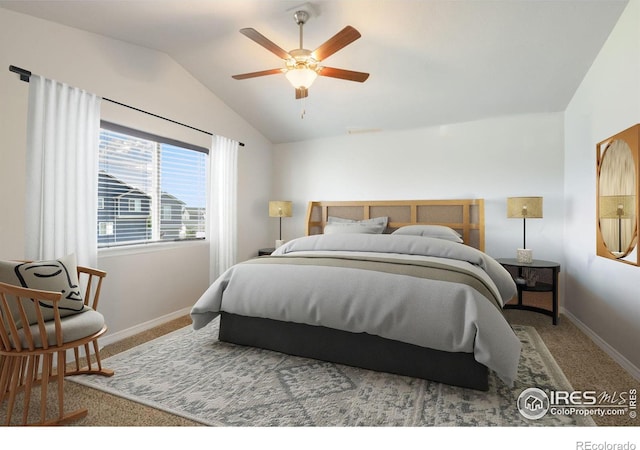 bedroom with ceiling fan, carpet floors, and vaulted ceiling