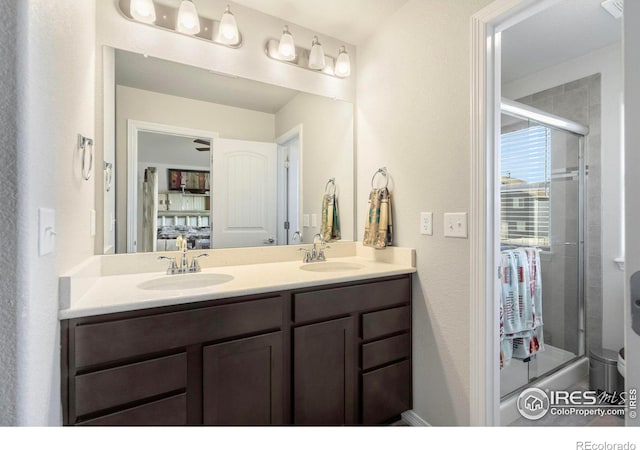 bathroom with vanity and a shower with shower door