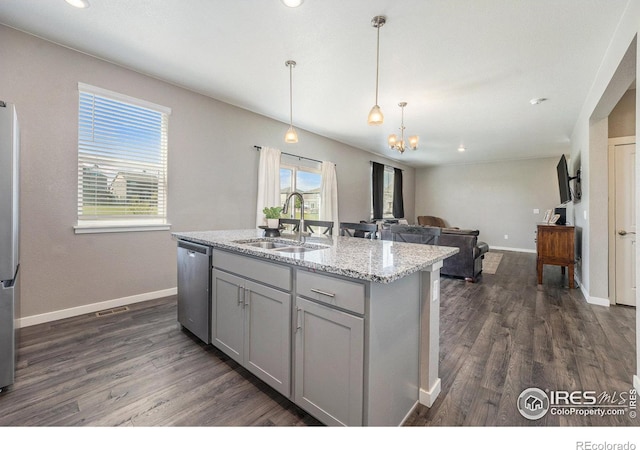 kitchen featuring a kitchen island with sink, appliances with stainless steel finishes, dark wood-type flooring, and sink