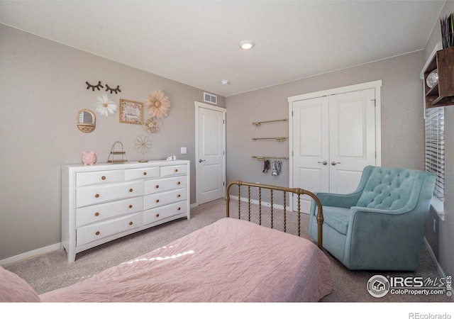 bedroom with light carpet and a closet