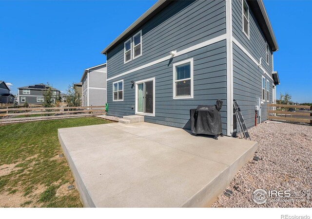 back of property featuring a yard and a patio area