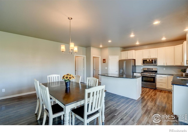 dining room with a chandelier, dark wood-type flooring, and sink