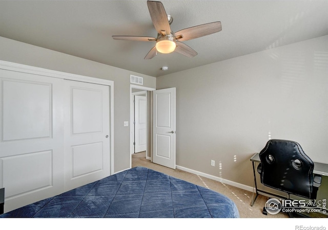 bedroom with ceiling fan, a closet, and carpet flooring