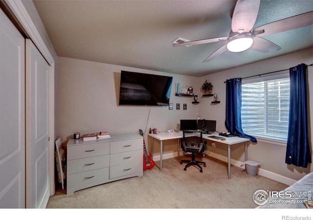 office space with light carpet and ceiling fan