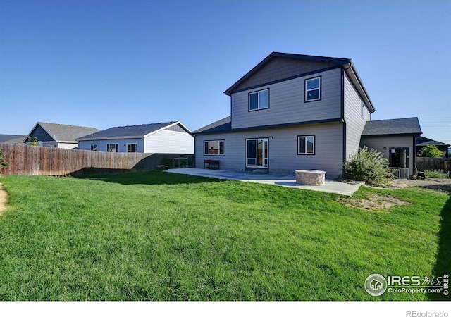 back of property featuring a lawn and a patio