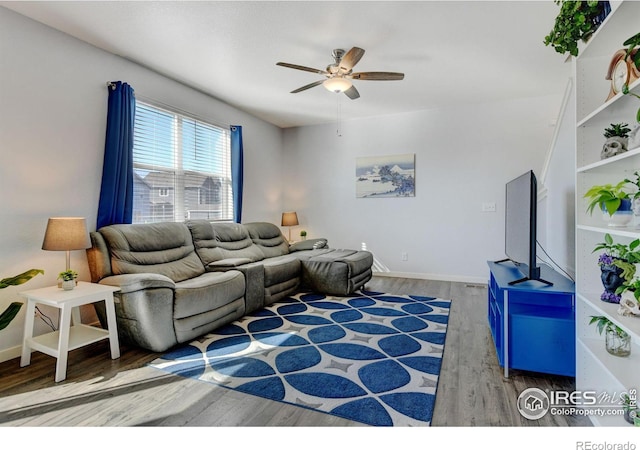 living room featuring ceiling fan and hardwood / wood-style flooring