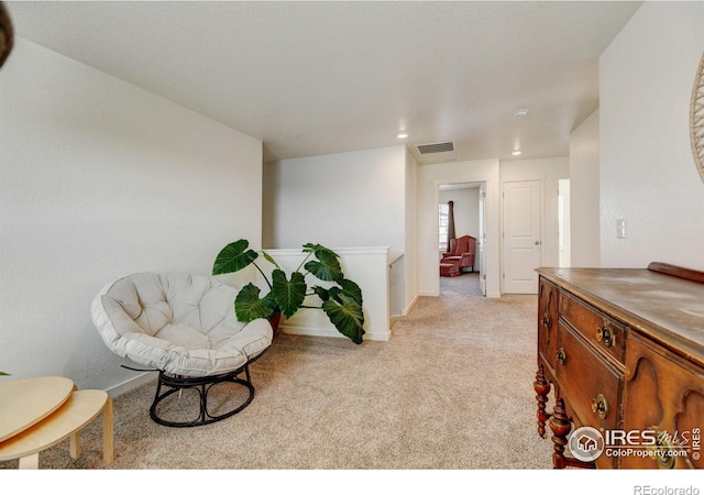 living area with light carpet