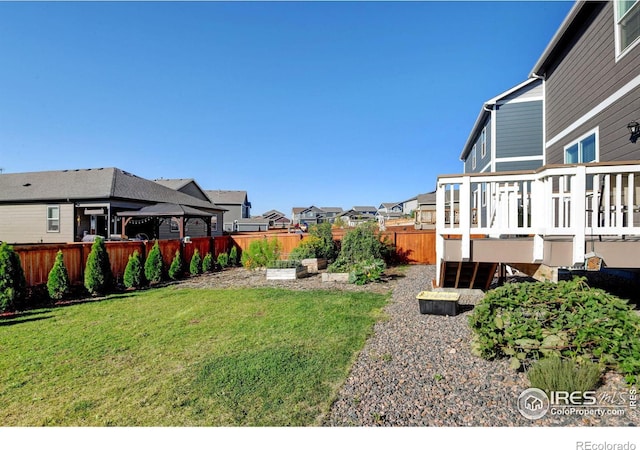 view of yard with a deck and a gazebo