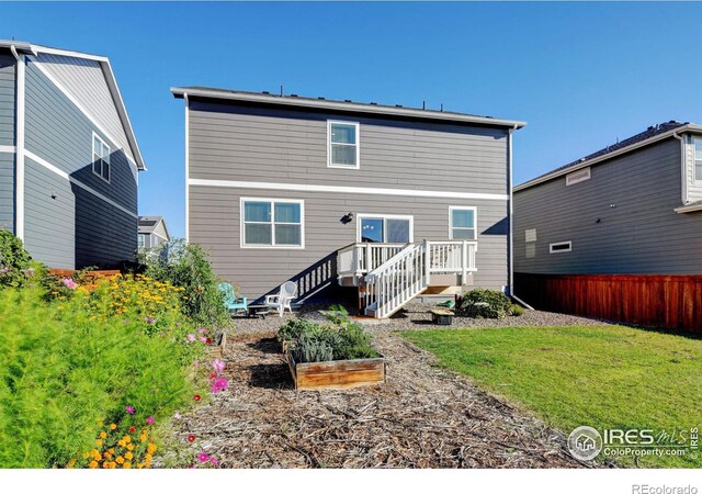 rear view of house with a yard