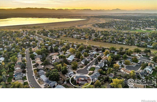 aerial view at dusk featuring a mountain view