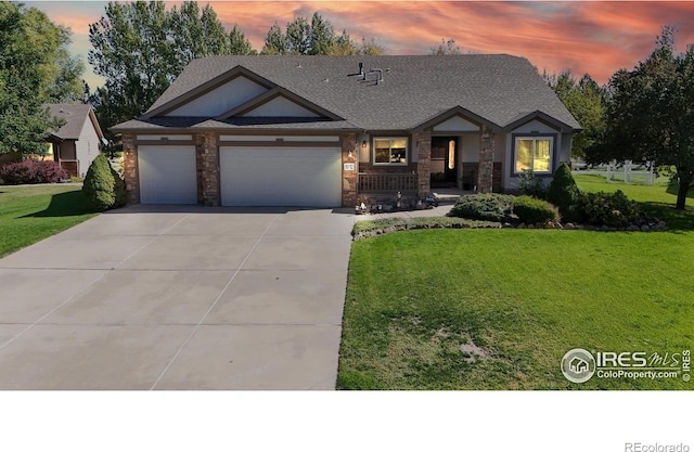 view of front of house featuring a garage and a yard