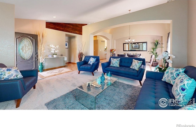 carpeted living room with lofted ceiling and a chandelier