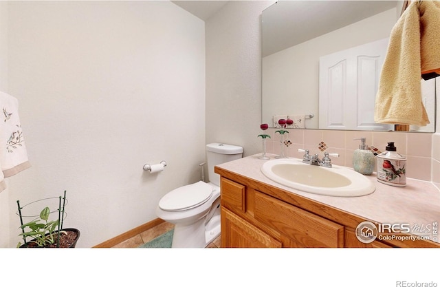 bathroom with tile patterned floors, decorative backsplash, toilet, and vanity