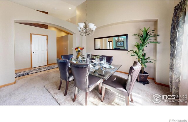 carpeted dining space featuring a chandelier