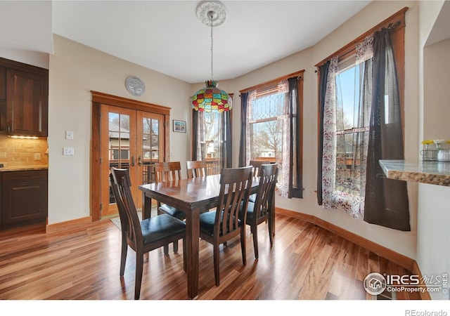 dining space featuring light hardwood / wood-style flooring and french doors