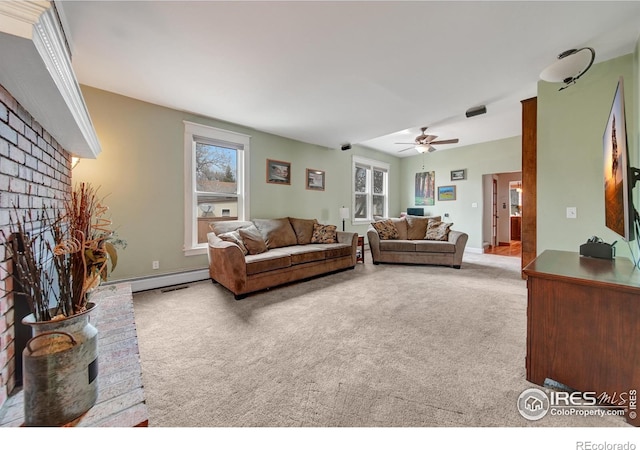 living room featuring carpet flooring, ceiling fan, and a brick fireplace