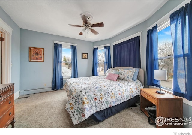 bedroom featuring ceiling fan, light colored carpet, and a baseboard radiator