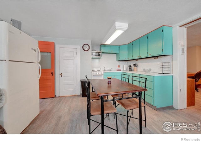 kitchen featuring light hardwood / wood-style flooring, white appliances, tasteful backsplash, and sink