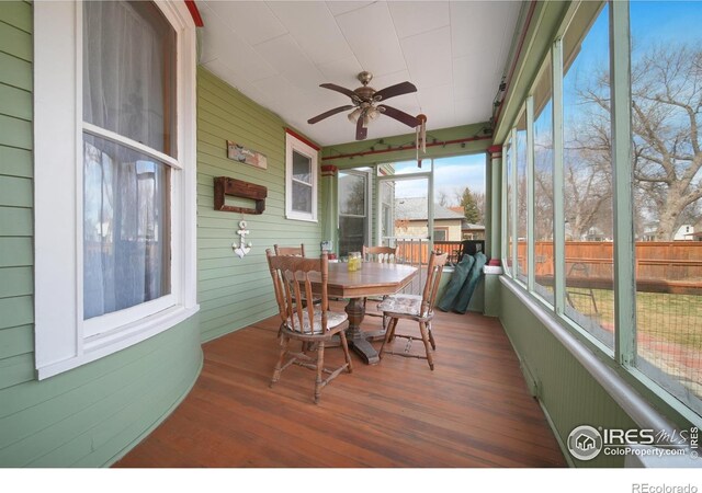 sunroom with ceiling fan and a wealth of natural light