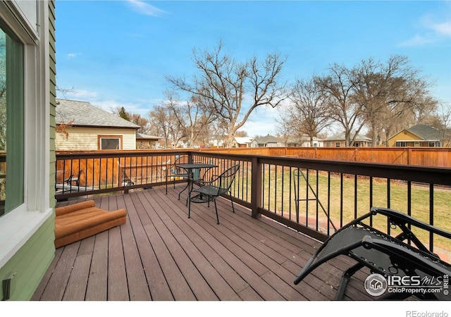 wooden deck featuring a yard