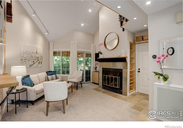 carpeted living room with high vaulted ceiling and a fireplace