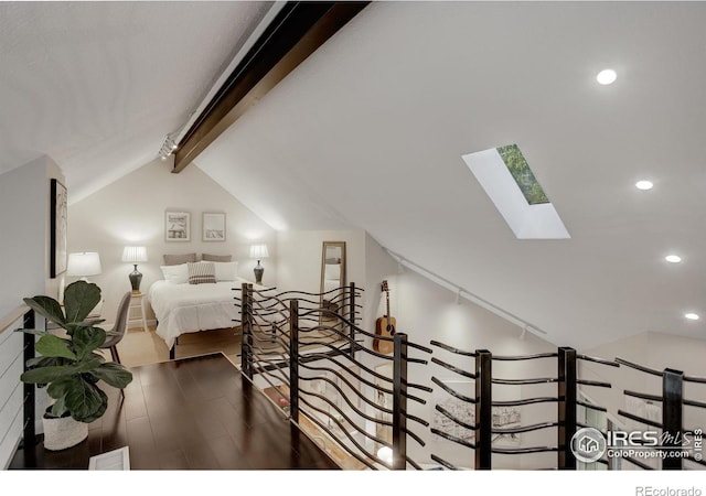 bedroom with wood-type flooring and lofted ceiling with skylight