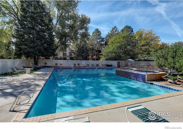 view of swimming pool featuring a patio area